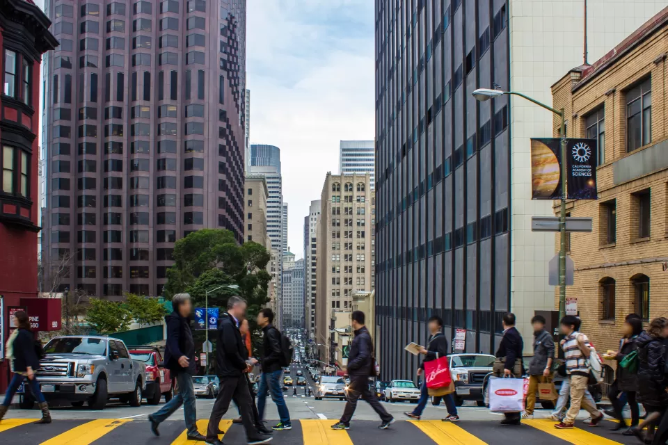People crossing street at crosswalk in downtown San Francisco, California